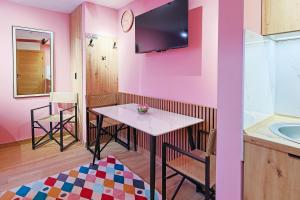 a pink room with a table and a sink at FourMountains-Igman in Sarajevo