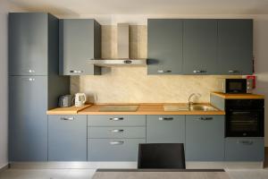 a kitchen with gray cabinets and a sink at F41 Private room ensuite shared flat in Il-Gżira