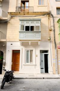 a motorcycle parked in front of a building at F41 Private room ensuite shared flat in Il-Gżira