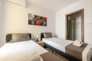 two beds in a room with white walls at F41 Private room ensuite shared flat in Il-Gżira