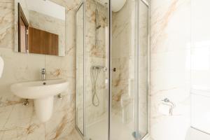 a bathroom with a sink and a shower at F41 Private room ensuite shared flat in Il-Gżira +13 photos
