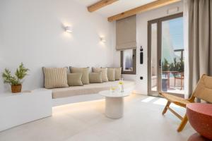 a living room with a couch and a table at The Lofts Paros Executive Suites in Naousa