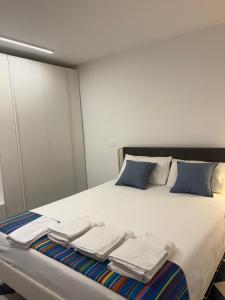 a bedroom with a bed with towels on it at Bordo piazza in Vasto