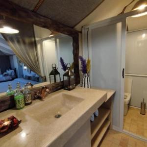 a bathroom with a sink and a large mirror at Best-Merzouga traditional camps in Merzouga