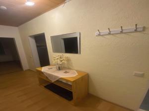 a room with a table with flowers on a wall at Ferienwohnung Sonnenschein mit Balkon in Lage +7 photos