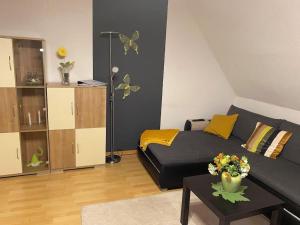 a living room with a couch and butterflies on the wall at Ferienwohnung Sonnenschein mit Balkon in Lage