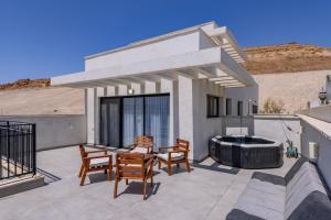 a patio with two chairs and a hot tub at זוהר על הים - ווילה ו-3 חדרי סטודיו מהממים עם בריכה בנווה זוהר in Neve Zohar +34 photos