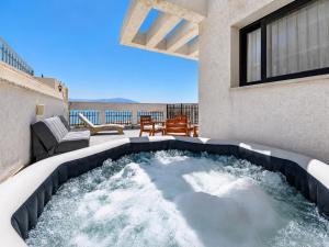 a hot tub on the balcony of a house at זוהר על הים - ווילה ו-3 חדרי סטודיו מהממים עם בריכה בנווה זוהר in Neve Zohar
