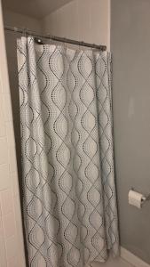 a shower curtain in a bathroom with a toilet at White Squirrel Cottage in Crawfordville +17 photos