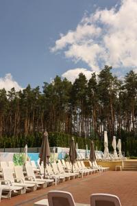 a group of chairs and umbrellas next to a pool at Kryve Ozero in Novoyavorivsk