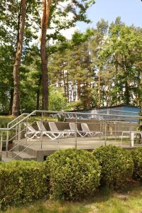 a group of chairs sitting on a bench in a park at Kryve Ozero in Novoyavorivsk