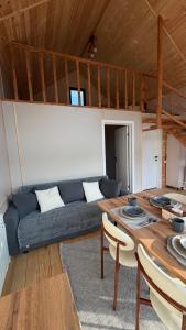 a living room with a blue couch and a table at ALAU villas in Saty