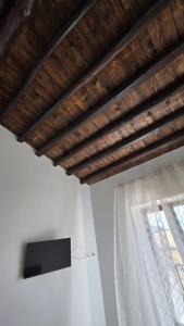 a flat screen tv on a wall next to a window at Sikania Agrirelais in Caccamo