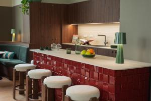 a kitchen with a counter with bar stools at Habyt Vienna in Vienna