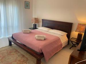 a bedroom with a large bed with two towels on it at Casa Luce in Milazzo