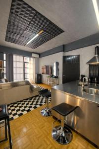 a kitchen with a counter and two bar stools at jim villa1 family apartment fast wi-fi free parking in Kyllini
