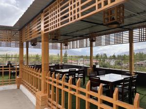 a pavilion with tables and chairs and a view at Blue Yak Resort in She