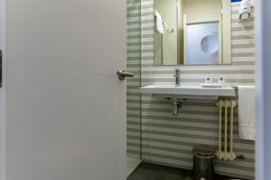 a bathroom with a sink and a mirror at Alda Altiana in Ourense +49 photos