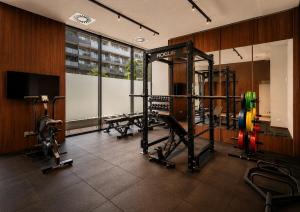 a gym with several tread machines in a room at Habyt Vienna in Vienna +29 photos