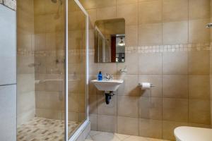 a bathroom with a shower and a sink at Comfort on Cabot in Edenvale