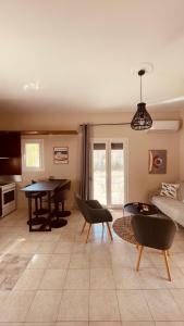 a living room with a table and a couch at Casa Bellina ,Potamos Private Garden & Free Parking in Evropoúloi