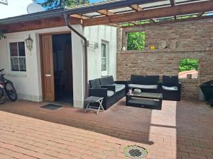 a patio with couches and a table on a brick patio at Ferienwohnung HEIDI in Donauwörth