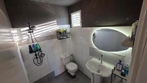 a bathroom with a sink and a toilet and a mirror at BOND Grand Suites in Beer Sheva +13 photos