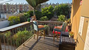 a balcony with two chairs and a table at BOND Grand Suites in Beer Sheva