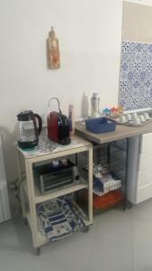a kitchen with a counter and a table with a sink at Green House in Briatico