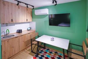 a kitchen with a white table and a sink at FourMountains-Jahorina in Sarajevo