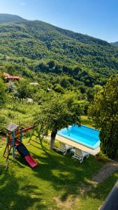 a house with a swimming pool and a playground at Сонита in Yamna