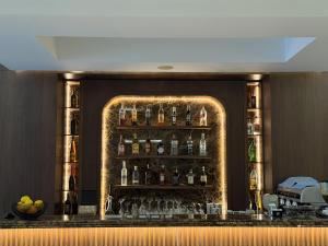 a bar with a bunch of bottles of alcohol at Hotel Vila Zeus in Rinas