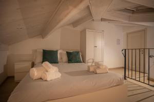 a bedroom with a large bed with towels on it at Il Grottino Relais & Spa in Gualdo Cattaneo +74 photos
