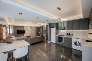 a kitchen and living room with a washer and dryer at L'Oceanica Beach Resort in Kemer +44 photos