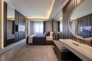 a bedroom with a bed and a sink and a tub at L'Oceanica Beach Resort in Kemer