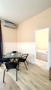 a dining room with a table and chairs and a bed at Hayrapetyan Guest House in Yeghegnadzor