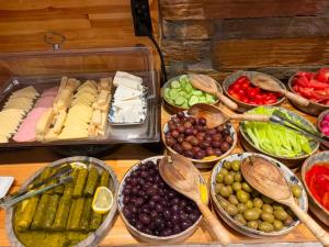 a table topped with bowls of different types of food at Lighthouse Hotel in Alexandroupoli