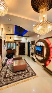 a living room with a couch and a chandelier at Checkpoint Backpacker Jaipur in Jaipur +20 photos