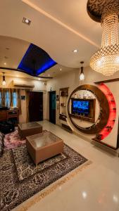 a living room with a couch and a tv at Checkpoint Backpacker Jaipur in Jaipur