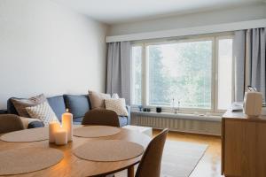 a living room with a table and a couch at Nordic Nova II by Elys Collection in Rovaniemi