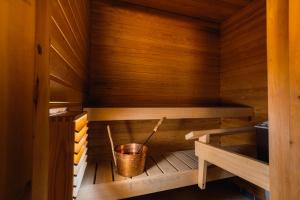 a wooden sauna with a bucket in it at Nordic Nova II by Elys Collection in Rovaniemi