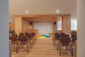 a large room with chairs and a projection screen at Residence Des Alpes in Cavalese +73 photos
