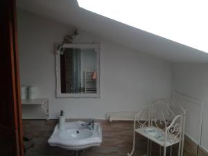 a white bathroom with a sink and a mirror at Affittacamere le Querce in Montefano +16 photos