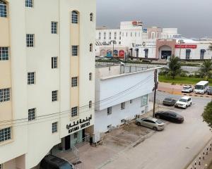 an aerial view of a building with a parking lot at أجنحة كتارا صلالة Katara Suites Salalah in Salalah