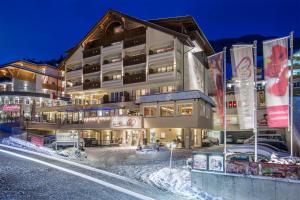 a hotel in the snow at night at Alpen-Herz Romantik & Spa - Adults Only in Ladis