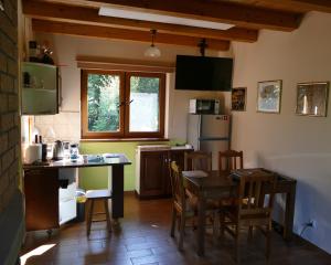 a kitchen with a table and some chairs and a table and a kitchen with at Plantacja Wierzby Agroturystyka in Haczów