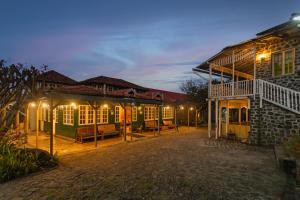 a house with a courtyard in front of it at night at Lilly's Valley Resort in Kodaikānāl