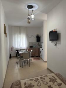 a kitchen and dining room with a table and a television at Guest House GT in Oni