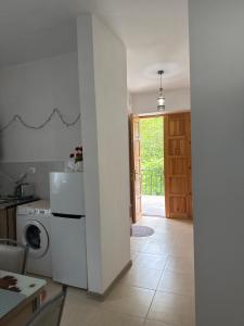 a kitchen with a washer and dryer next to a door at Guest House GT in Oni