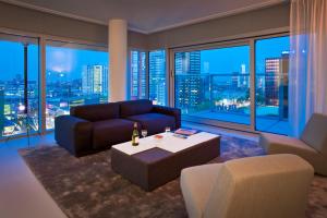 a living room with a couch and a table at Urban Residences Rotterdam in Rotterdam